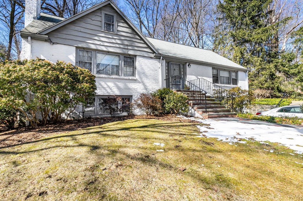 177 Varick Road Newton, MA 02468 - Photo 23 of 29 a front view of a house with a yard and trees