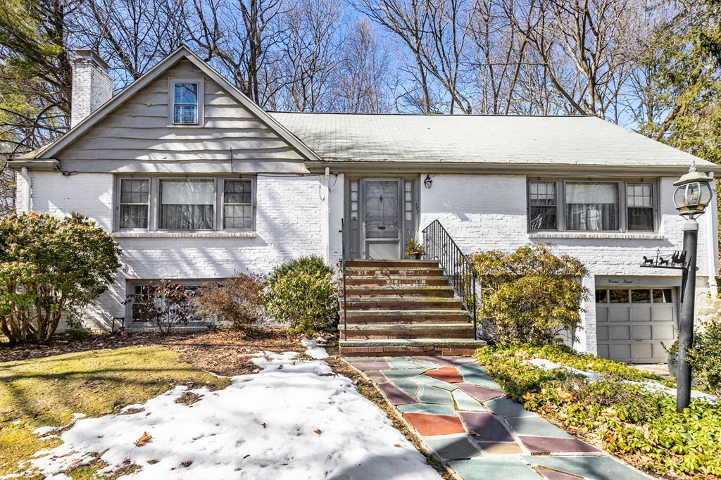 177 Varick Road Newton, MA 02468 - Photo 24 of 29 a front view of a house with a yard outdoor seating and garage