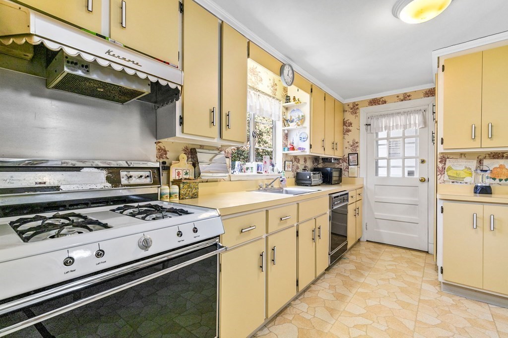 177 Varick Road Newton, MA 02468 - Photo 3 of 29 a kitchen with appliances cabinets and a window