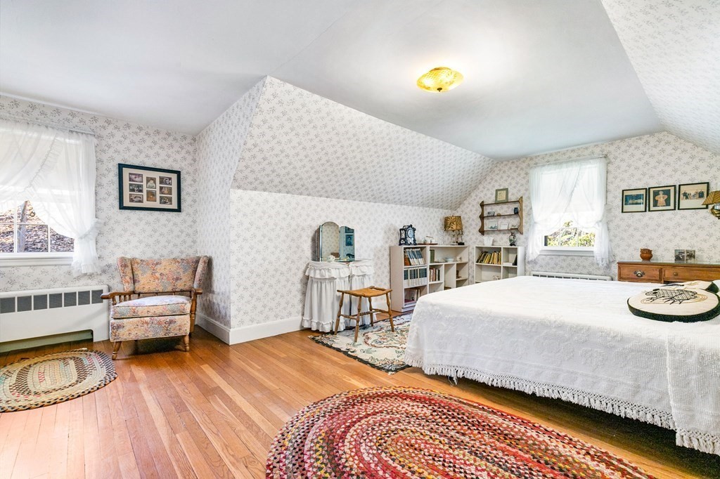 177 Varick Road Newton, MA 02468 - Photo 7 of 29 a bedroom with a bed and a chandelier