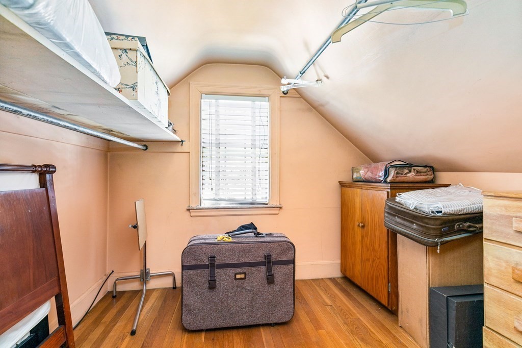 177 Varick Road Newton, MA 02468 - Photo 9 of 29 a living room with a bed and a mirror
