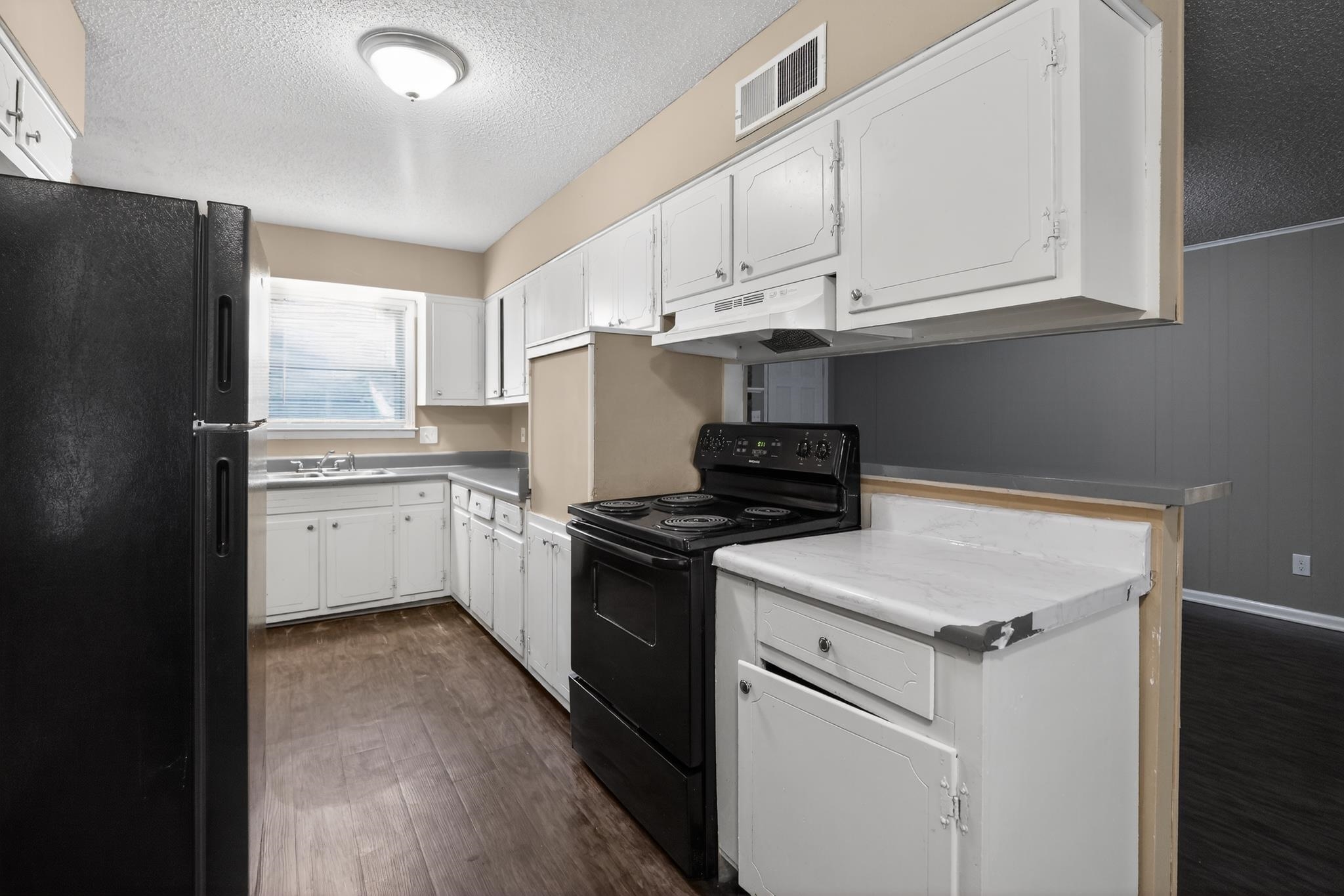 2015 East Holmes Road Memphis, TN 38116 - Photo 22 of 34 a kitchen with cabinets appliances a sink and a window