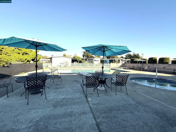 a view of a tables and chairs under an umbrella