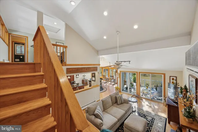 a view of staircase with wooden floor and white walls