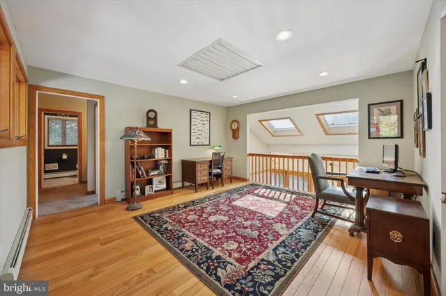 a bedroom with a bed a flat screen tv and dresser