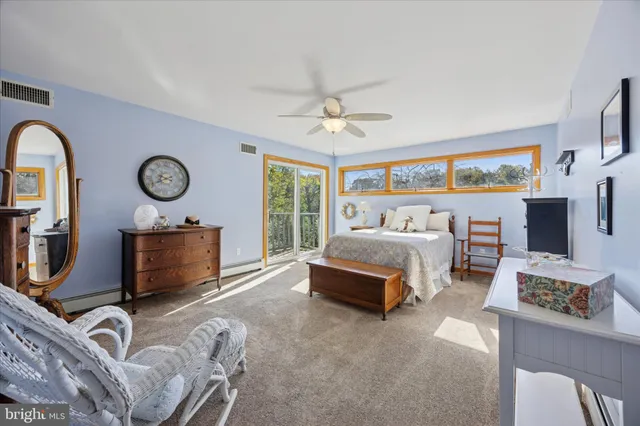 a bedroom with furniture and a mirror