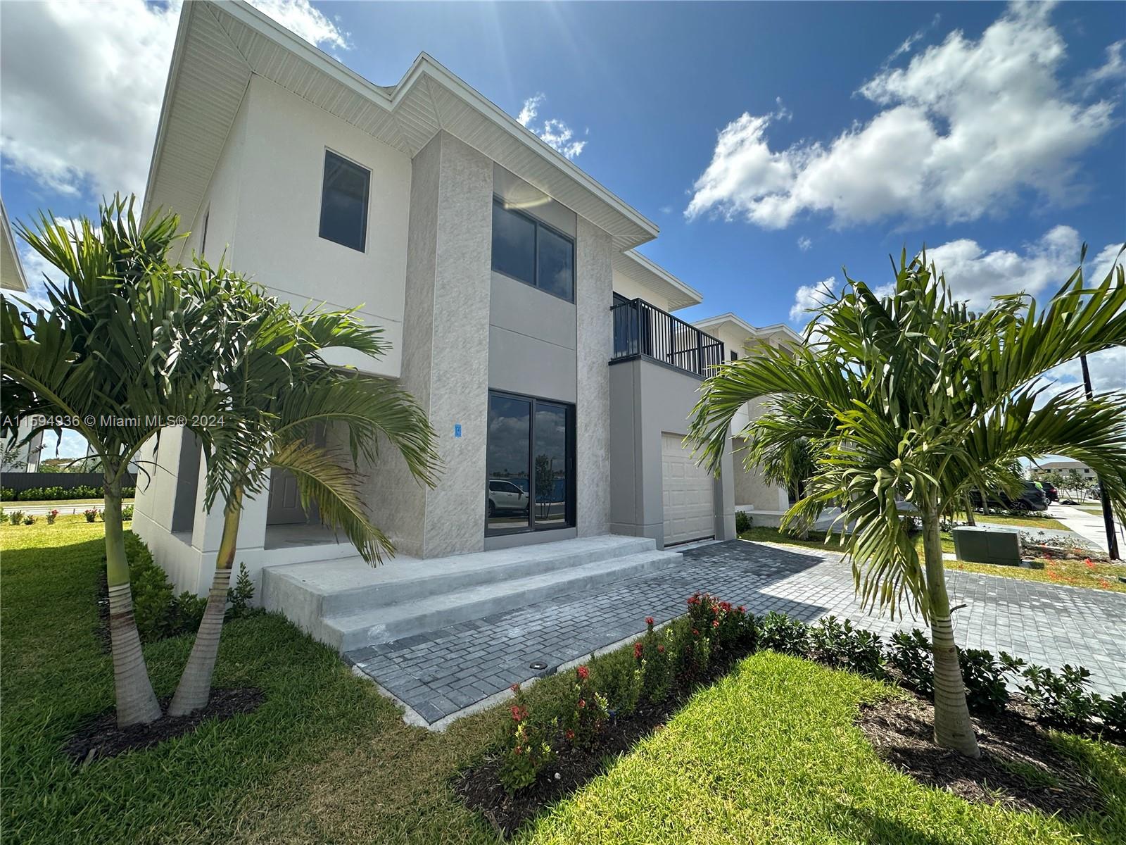 232 Northwest 13th Street, Unit 232 Homestead, FL 33030 - Photo 1 of 14 a front view of a house with garden