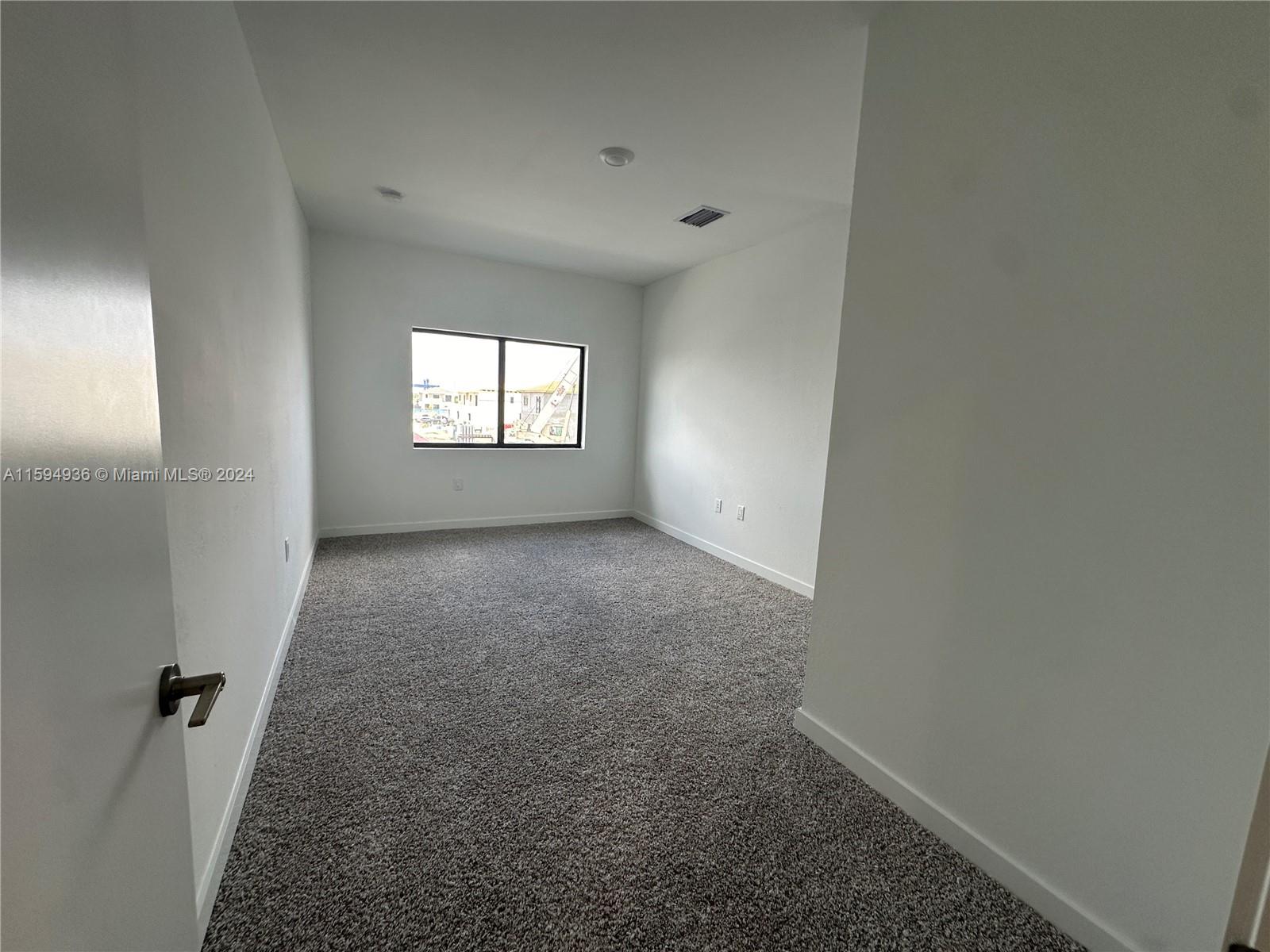 232 Northwest 13th Street, Unit 232 Homestead, FL 33030 - Photo 11 of 14 an empty room with windows