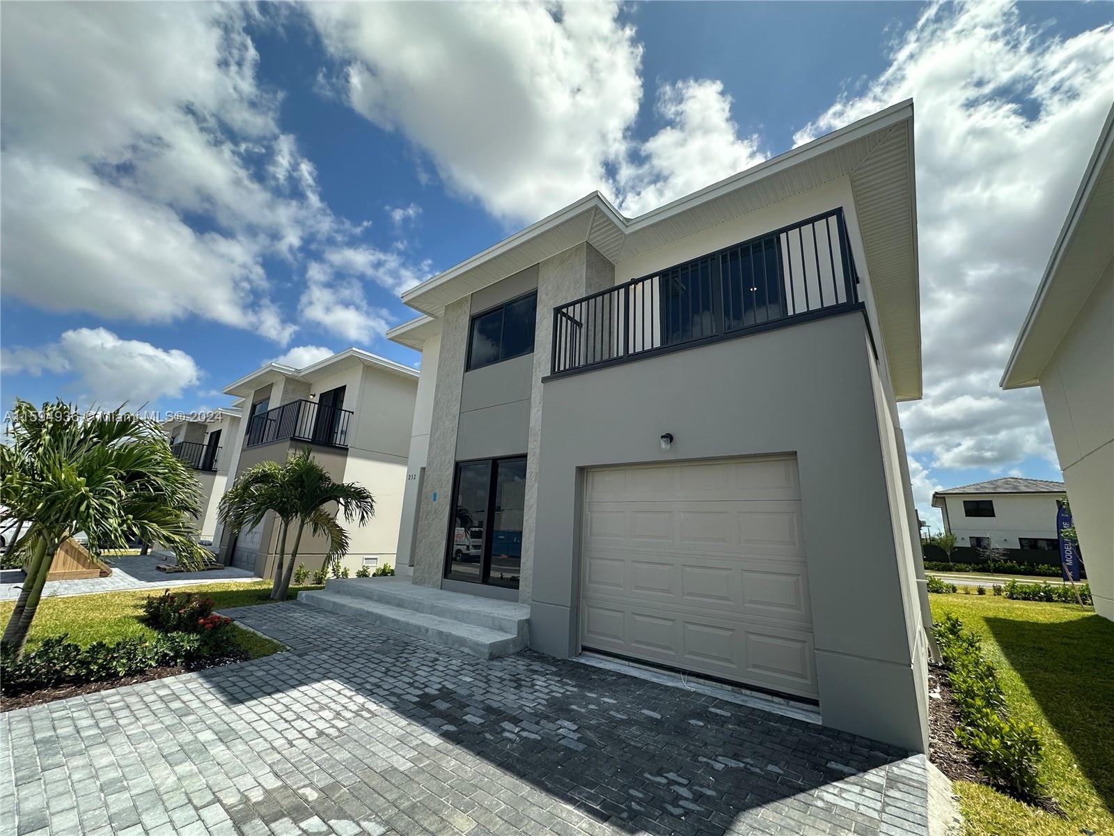 232 Northwest 13th Street, Unit 232 Homestead, FL 33030 - Photo 2 of 14 a front view of a house with a yard
