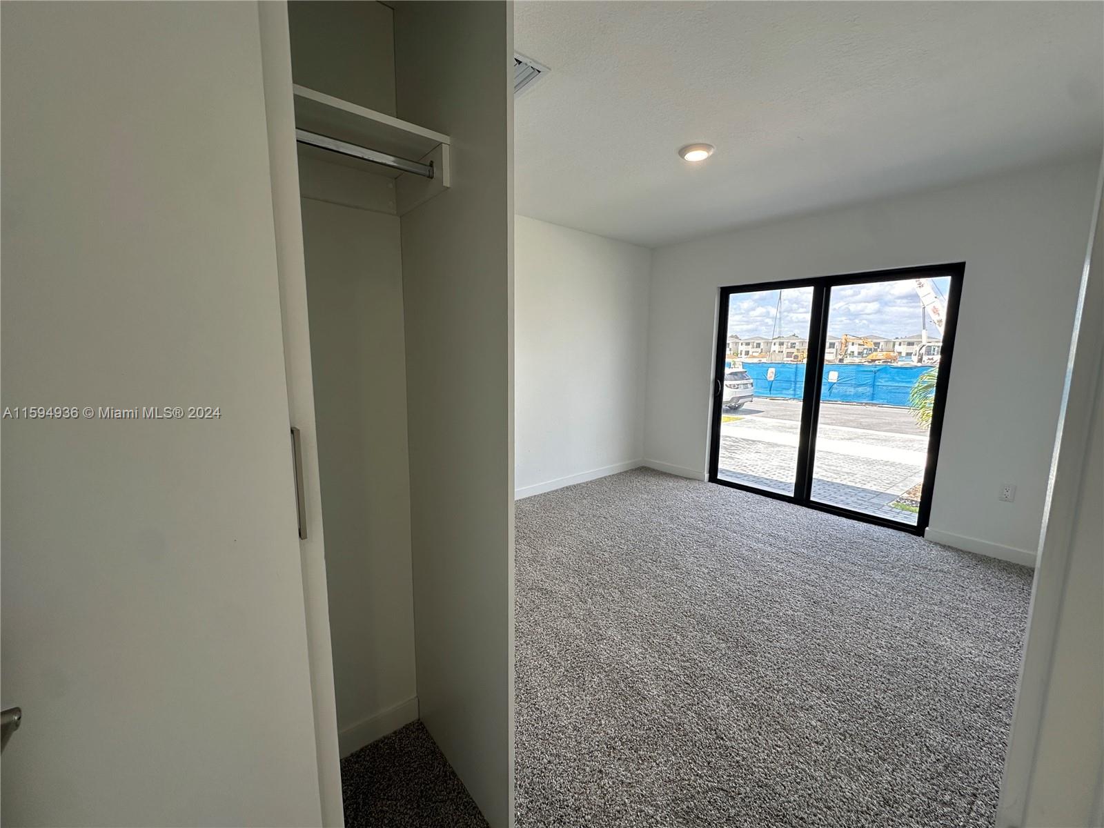 232 Northwest 13th Street, Unit 232 Homestead, FL 33030 - Photo 4 of 14 an empty room with windows and closet