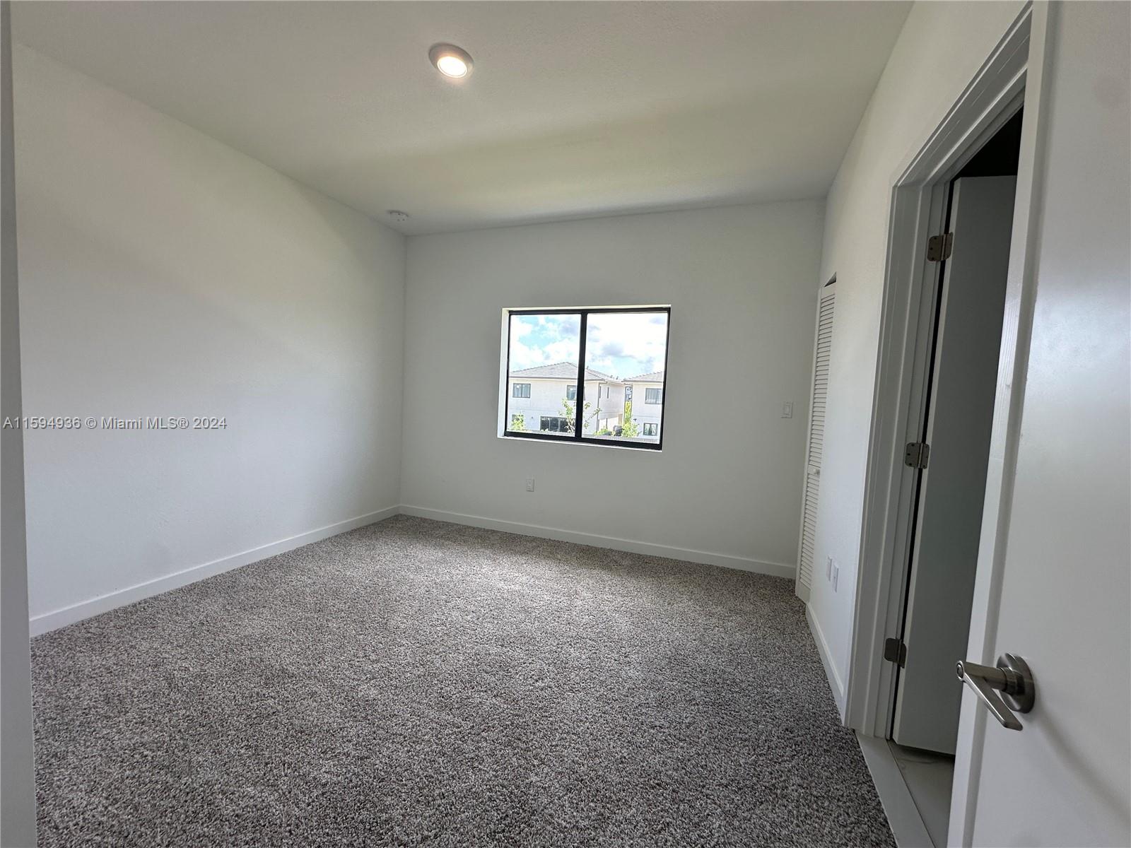 232 Northwest 13th Street, Unit 232 Homestead, FL 33030 - Photo 10 of 14 an empty room with windows