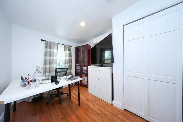 a view of a workspace with furniture and wooden floor