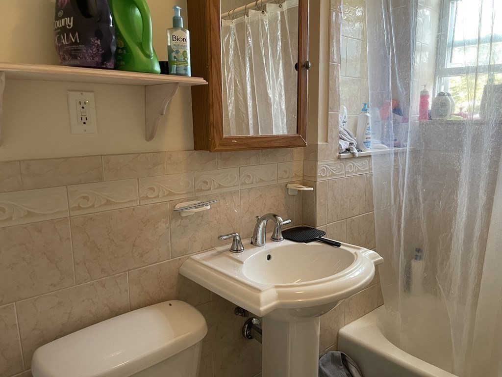 133 Fayerweather Street Cambridge, MA 02138 - Photo 12 of 27 a bathroom with a sink a toilet and a mirror
