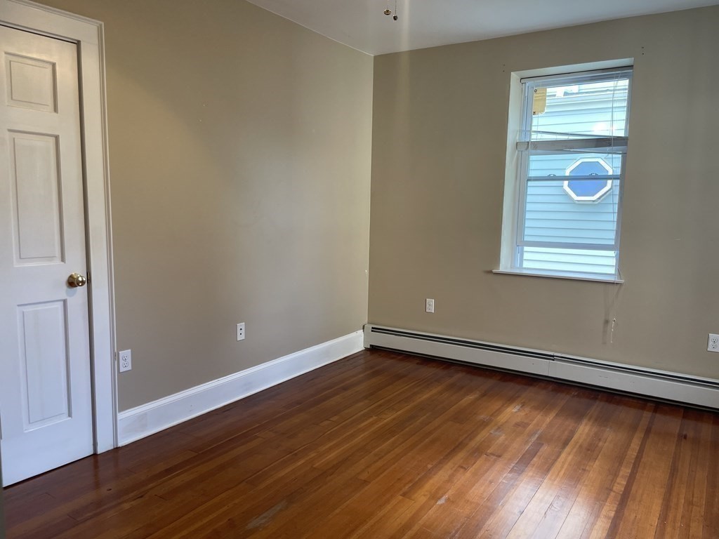 133 Fayerweather Street Cambridge, MA 02138 - Photo 14 of 27 an empty room with wooden floor and windows