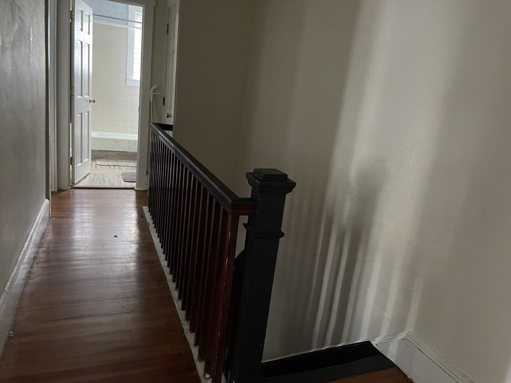 133 Fayerweather Street Cambridge, MA 02138 - Photo 18 of 27 a view of a hallway with wooden floor