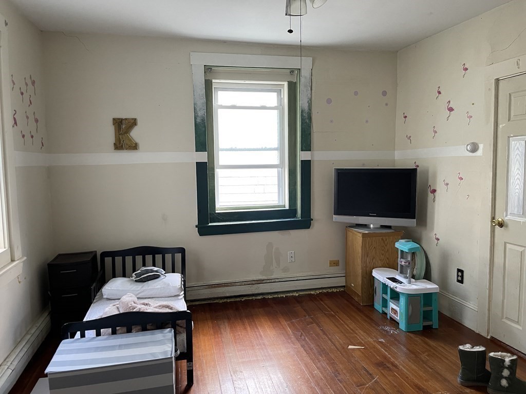 133 Fayerweather Street Cambridge, MA 02138 - Photo 19 of 27 a living room with furniture and a flat screen tv