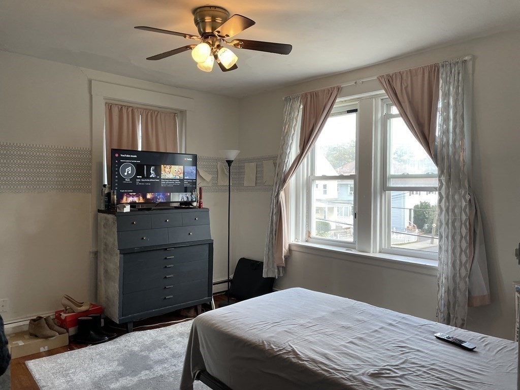 133 Fayerweather Street Cambridge, MA 02138 - Photo 20 of 27 a bedroom with a bed and a television