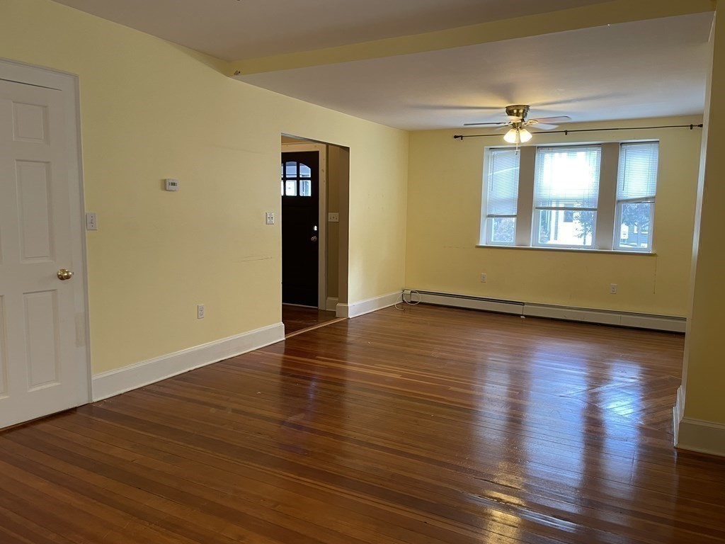 133 Fayerweather Street Cambridge, MA 02138 - Photo 3 of 27 an empty room with wooden floor and windows