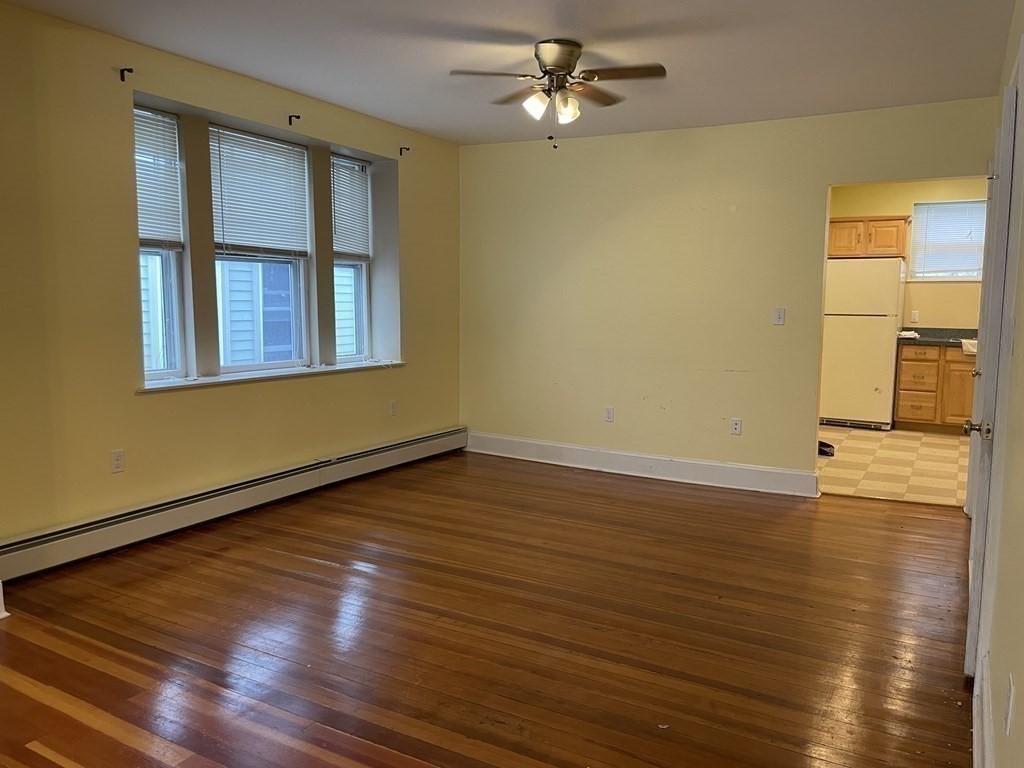 133 Fayerweather Street Cambridge, MA 02138 - Photo 4 of 27 a view of empty room with wooden floor and fan