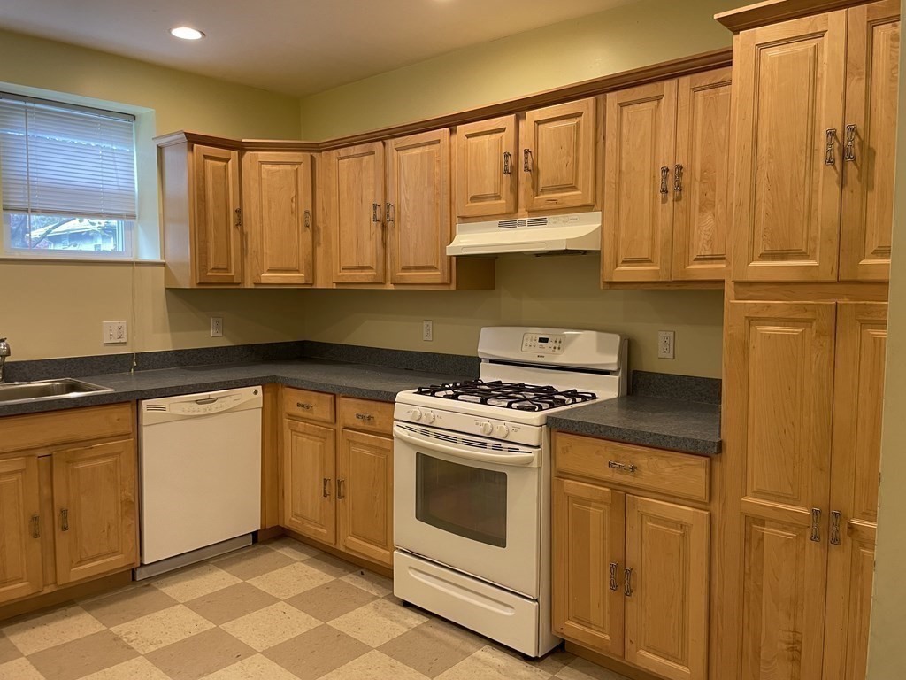 133 Fayerweather Street Cambridge, MA 02138 - Photo 5 of 27 a kitchen with granite countertop cabinets stainless steel appliances and a sink