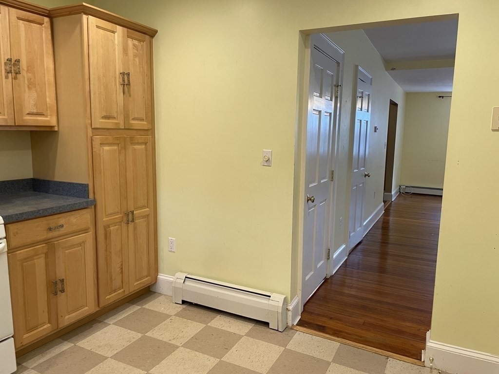 133 Fayerweather Street Cambridge, MA 02138 - Photo 7 of 27 a view of a hallway with wooden floor and staircase