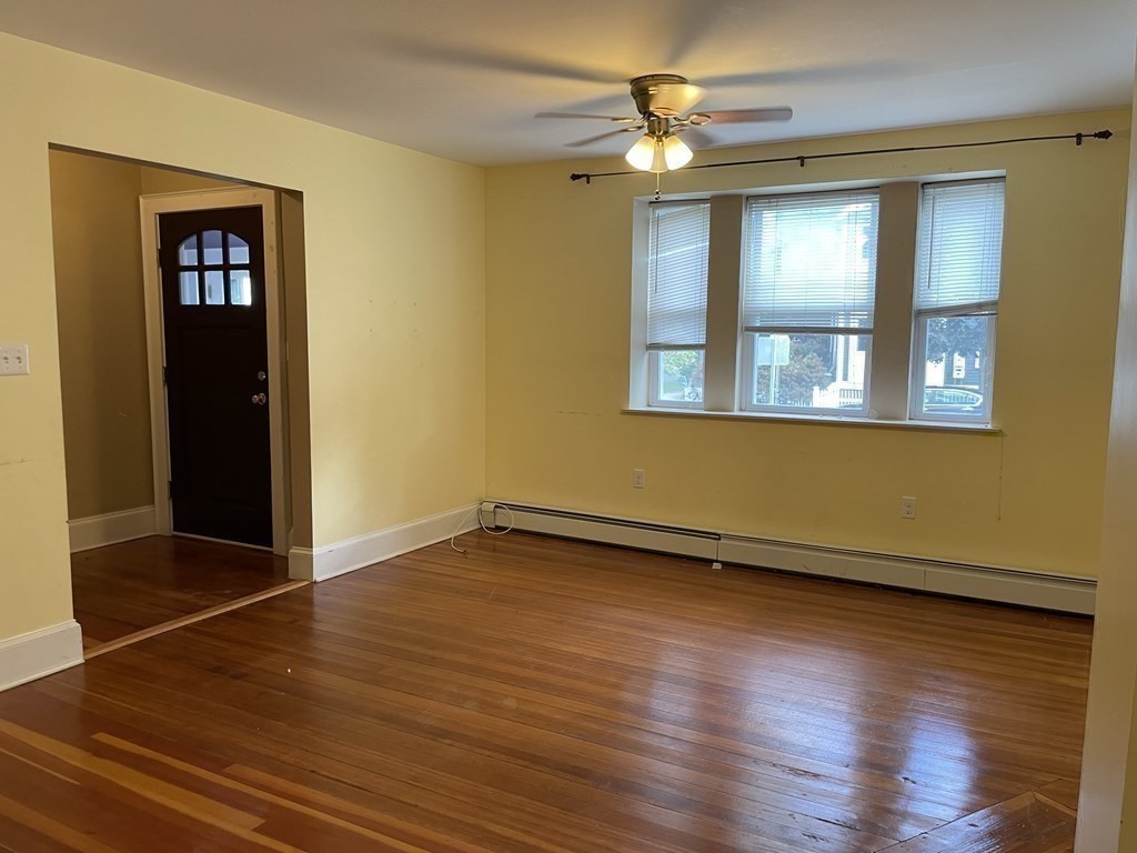 133 Fayerweather Street Cambridge, MA 02138 - Photo 9 of 27 a view of an empty room with wooden floor and a window
