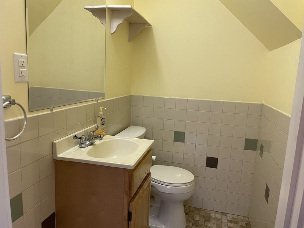 133 Fayerweather Street Cambridge, MA 02138 - Photo 10 of 27 a bathroom with a sink mirror and toilet