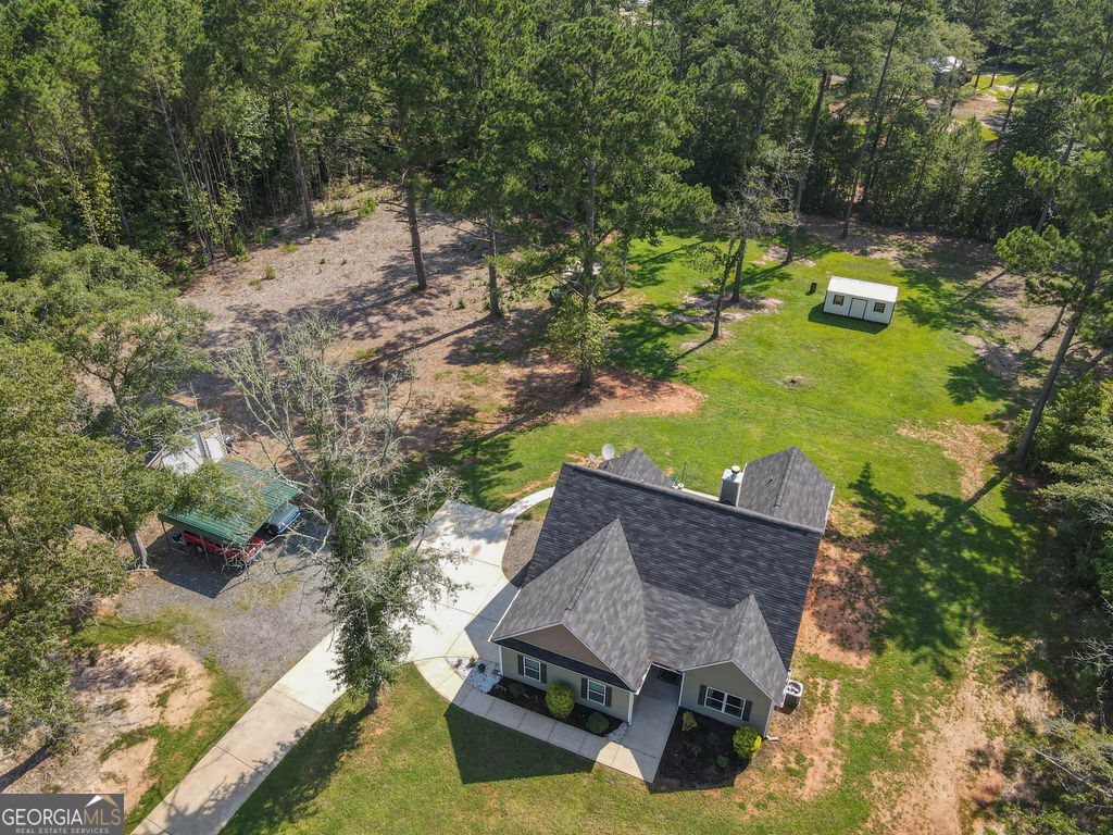 2046 Mcwilliams Barber Road Luthersville, GA 30251 - Photo 13 of 43 a aerial view of a house with swimming pool and large trees