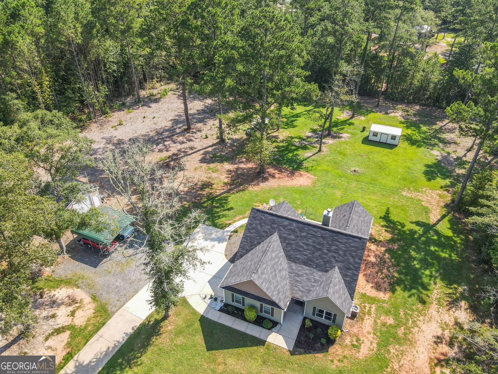 2046 Mcwilliams Barber Road Luthersville, GA 30251 - Photo 16 of 43 an aerial view of a house with swimming pool and large trees