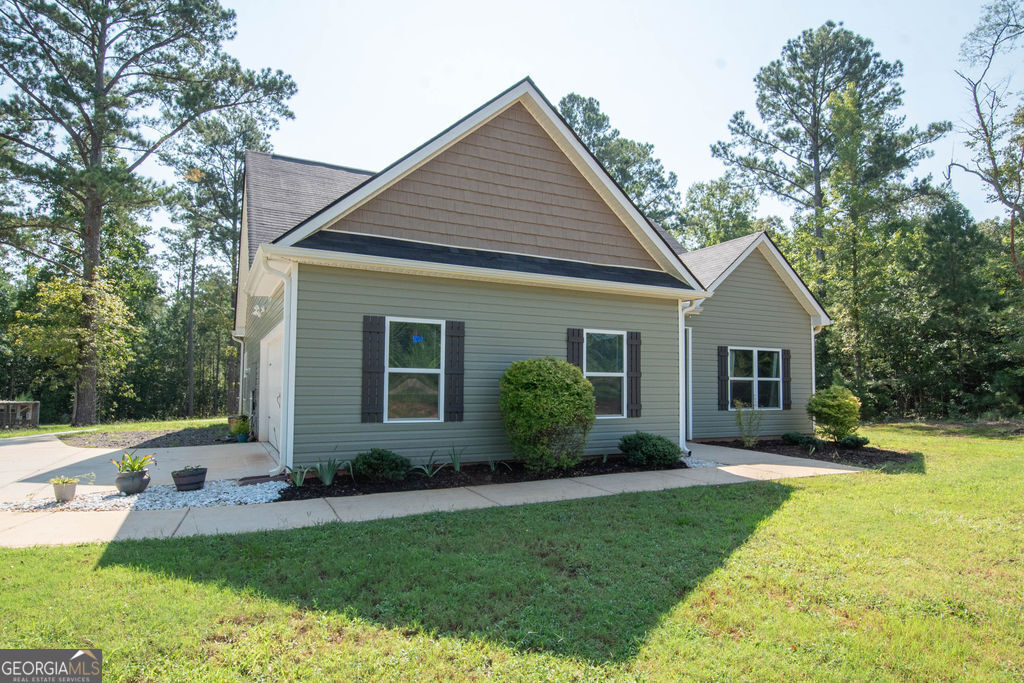 2046 Mcwilliams Barber Road Luthersville, GA 30251 - Photo 2 of 43 a view of a house with a yard and potted plants