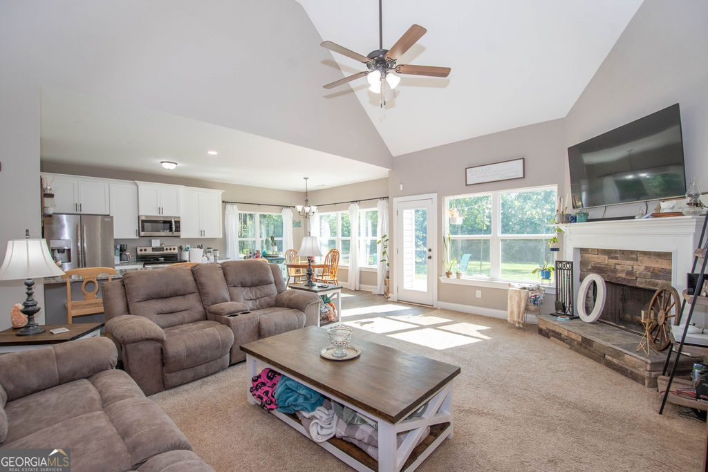 2046 Mcwilliams Barber Road Luthersville, GA 30251 - Photo 21 of 43 a living room with furniture a flat screen tv and a fireplace