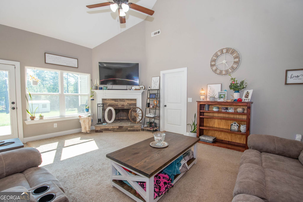2046 Mcwilliams Barber Road Luthersville, GA 30251 - Photo 22 of 43 a living room with furniture a flat screen tv and a fireplace