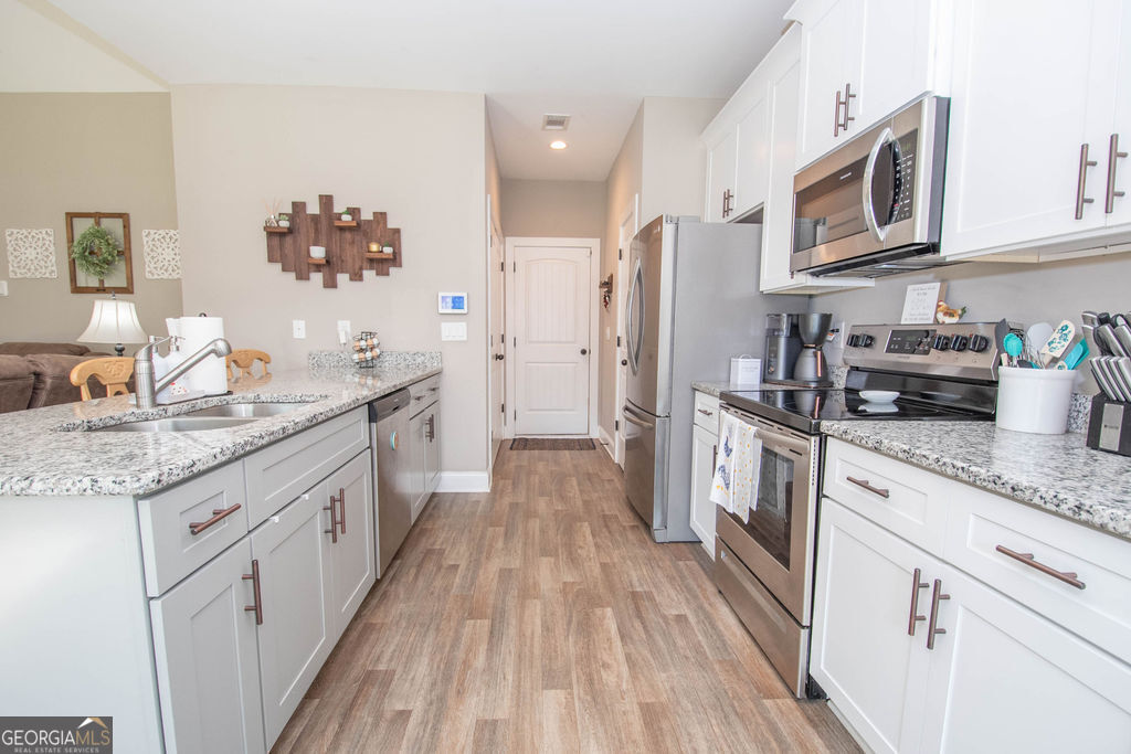 2046 Mcwilliams Barber Road Luthersville, GA 30251 - Photo 29 of 43 a kitchen with a sink dishwasher stove and refrigerator