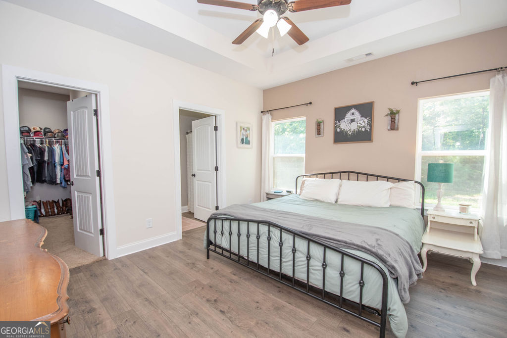 2046 Mcwilliams Barber Road Luthersville, GA 30251 - Photo 30 of 43 a bedroom with a large bed and a chandelier