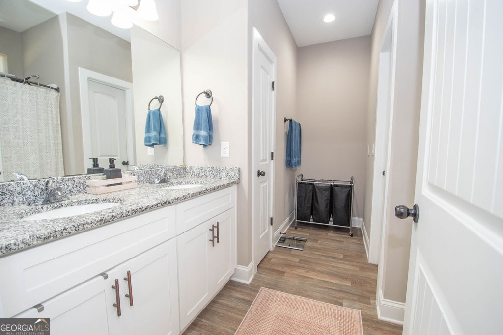 2046 Mcwilliams Barber Road Luthersville, GA 30251 - Photo 32 of 43 a bathroom with a granite countertop sink and a mirror