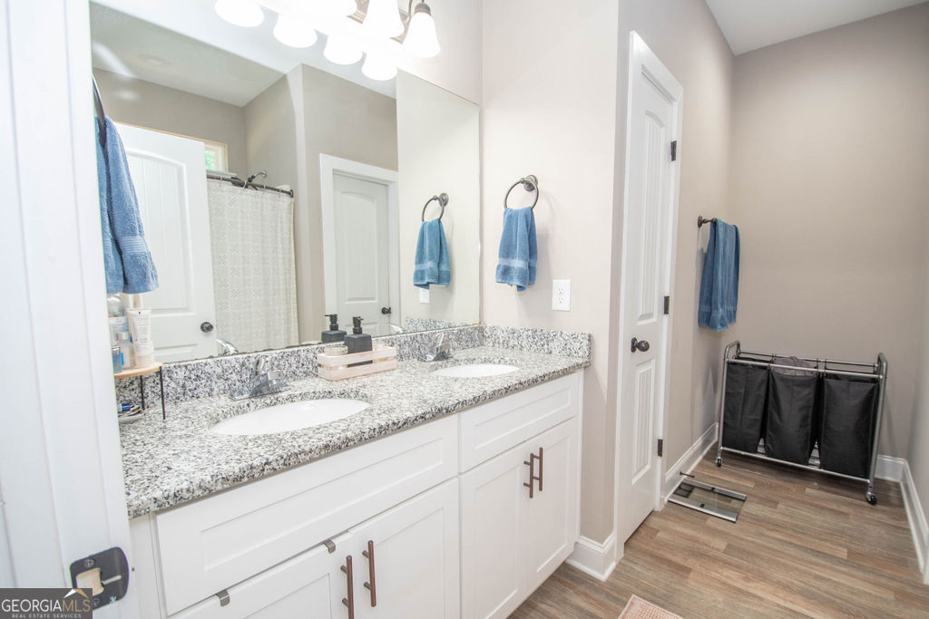 2046 Mcwilliams Barber Road Luthersville, GA 30251 - Photo 33 of 43 a bathroom with a granite countertop sink and a mirror
