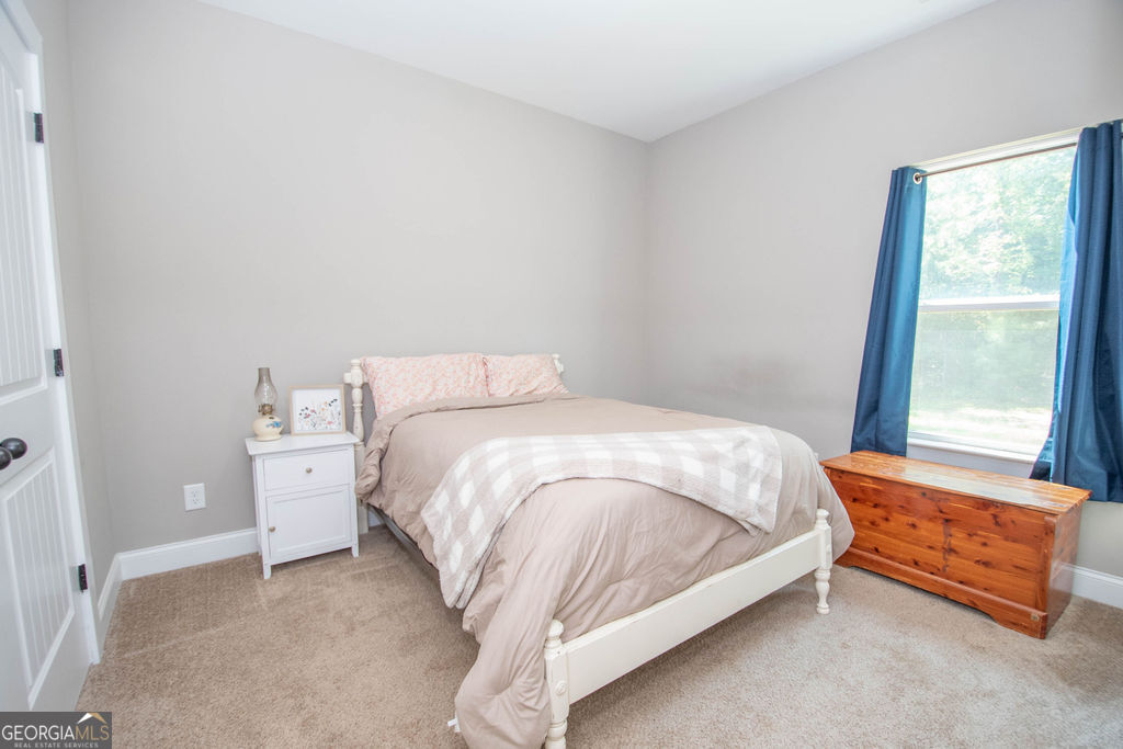 2046 Mcwilliams Barber Road Luthersville, GA 30251 - Photo 39 of 43 a bed sitting in a bedroom next to a window
