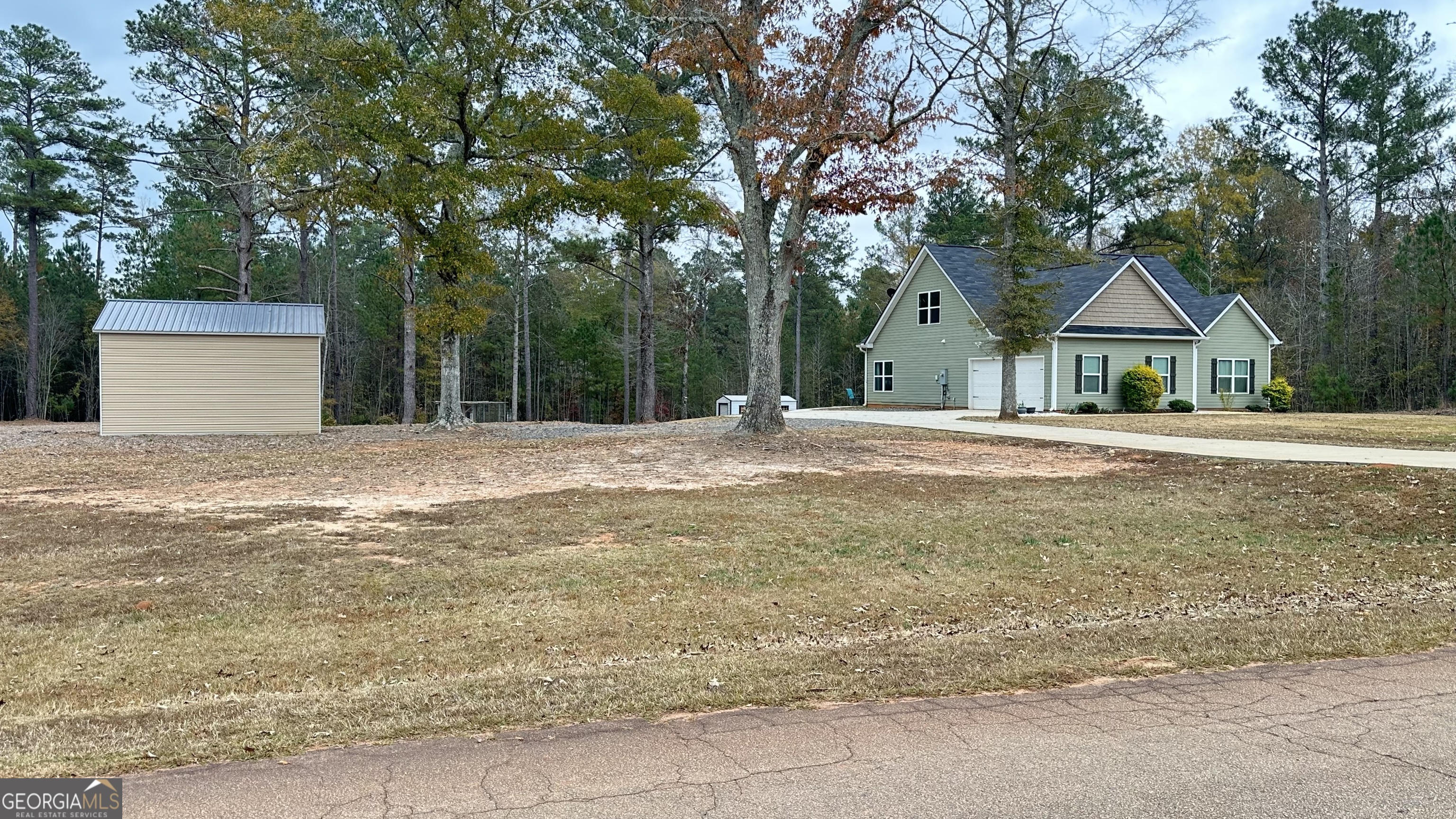 2046 Mcwilliams Barber Road Luthersville, GA 30251 - Photo 10 of 43 a front view of a house with a yard and trees