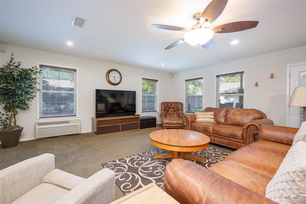 1027 Stanley Street Denton, TX 76201 - Photo 13 of 38 a living room with furniture a fireplace and a window