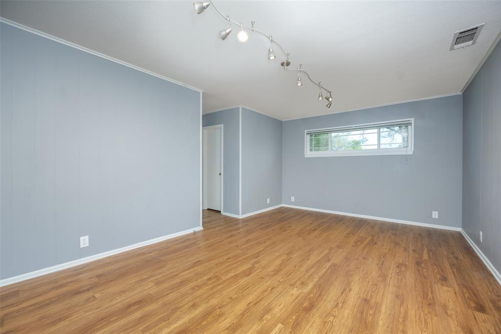 1027 Stanley Street Denton, TX 76201 - Photo 20 of 38 an empty room with wooden floor and windows