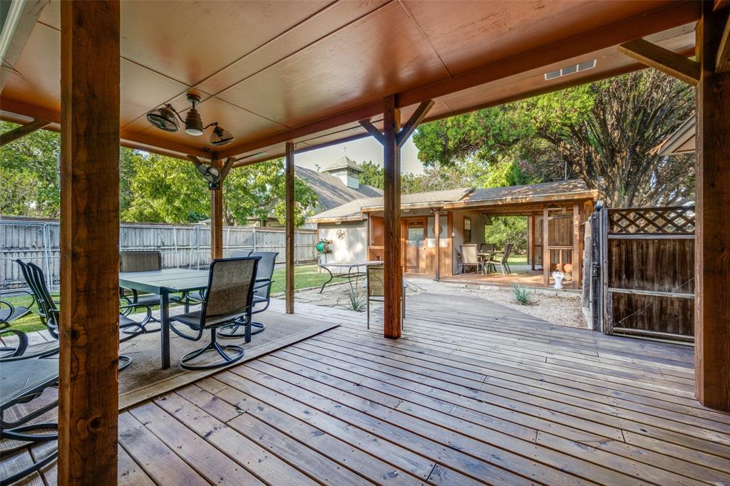 1027 Stanley Street Denton, TX 76201 - Photo 30 of 38 a view of a patio with table and chairs floor to ceiling window with wooden floor