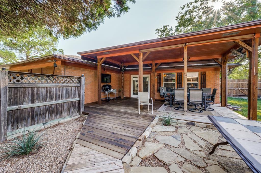1027 Stanley Street Denton, TX 76201 - Photo 32 of 38 a view of a patio with table and chairs and wooden floor