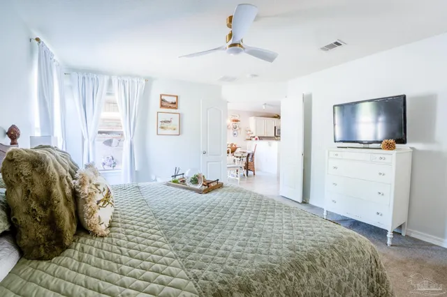 a bedroom with a bed and flat screen tv