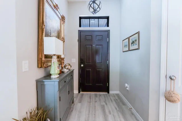 a view of hallway with wooden floor