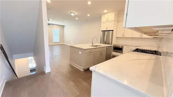 a kitchen with a sink stove and cabinets