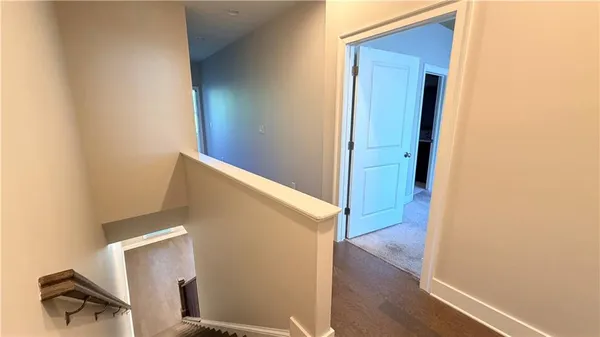 a view of empty room with wooden floor and ceiling fan