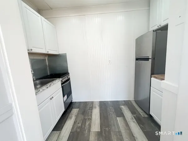 a kitchen with a refrigerator and a stove