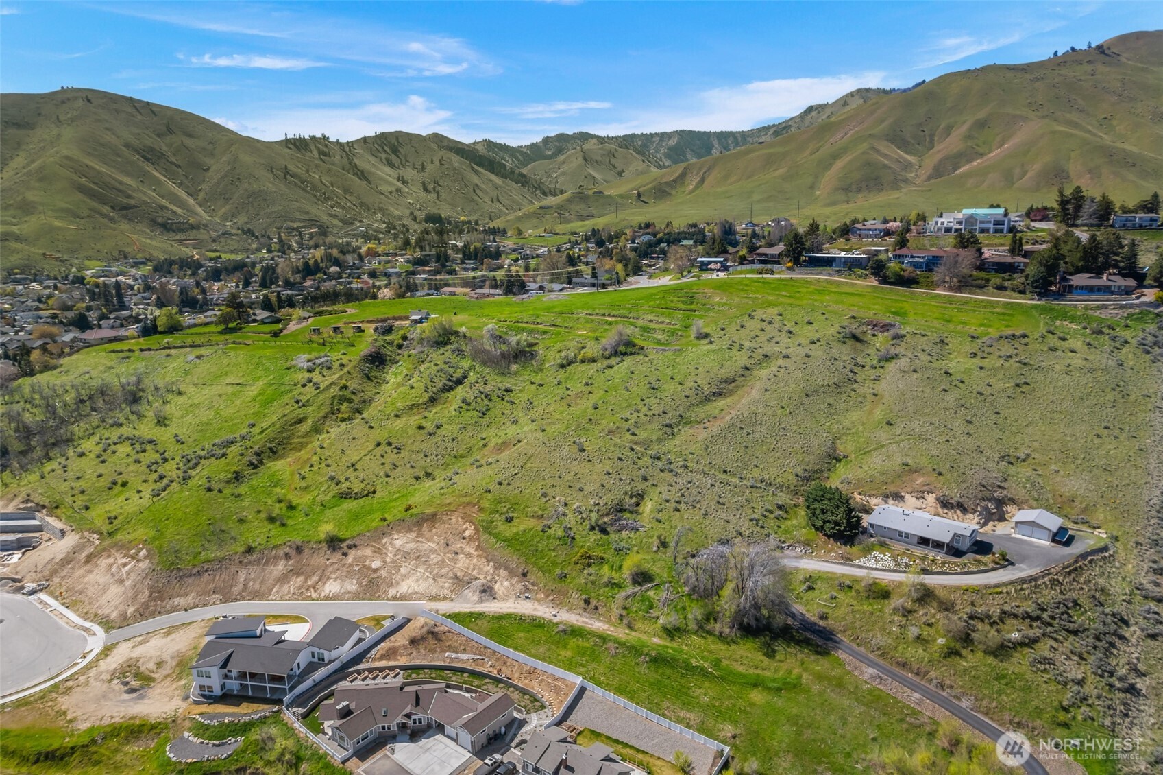 935 Silas Lane Wenatchee, WA 98801 - Photo 12 of 24 a view of a lush green hillside and houses