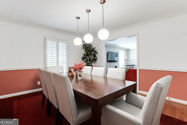 a view of a dining room and a table and chairs