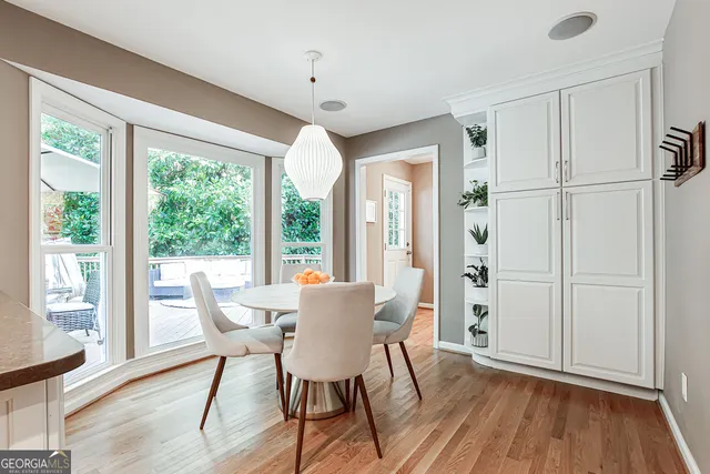 a view of a dining room with furniture window and wooden floor